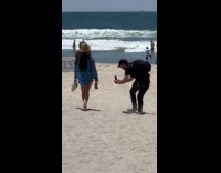 Collab IITW - Man Records Lady Walk on Beach Steadily