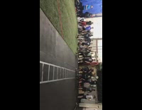 Guy wearing cleats slips on floor during football practice