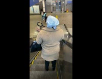 Lady wears white plastic bag on head 