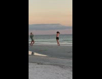 Woman spaghetti top hold hair beach sunset