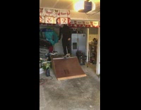 Guy rides skateboard down ramp falls garage