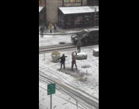 Two guys film dance video street snow