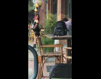 Black dress girl poses brick building backpack