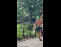 Shirtless joker walks around park 