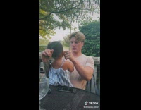 Guy with kid on lap fixes her hair 