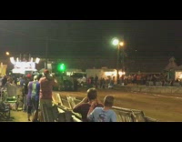 Green monster truck drives people cheer event