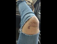 Woman draws star wars tattoo on knee