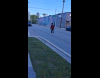 Man checkered outfit limp walk on street