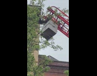 Tall industrial ladder leading up to giant beehive 