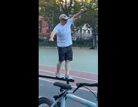 Man balances on metal beam at park 