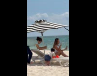 Woman uses tablet for video at beach