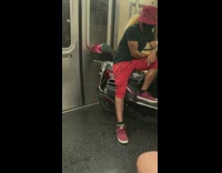 Red bucket hat guy sits motorcycle subway 