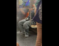 Man in subway train fan on neck