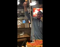 Guy does pizza cheese pull drops slice