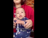 Mom makes baby dance points middle finger 