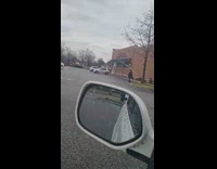 Man walks with Chucky doll at parking lot