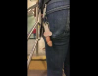 Guy has penis keychains hanging from pocket while walking in subway station