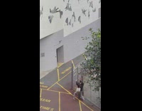 Woman angles and did a hand frame at the art on the wall