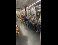 Man black tank top with Spider-Man mask in the train