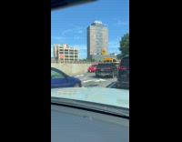 Collab WINY - Red car drive reverse on Brooklyn bridge