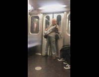 Man plays keyboard piano hung around his neck on subway train