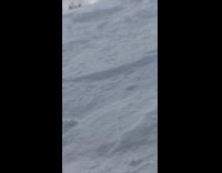 Collab JerrySlams - Snowboarder jumps off slope and slides down hill