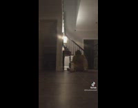Guy jumps off second floor in house and lands on butt