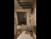 Woman shows fallen ceiling after hurricane