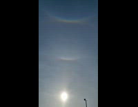 Four rainbows over the sun snow overcast