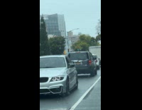 Collab WINY - Silver car drives backwards on the road