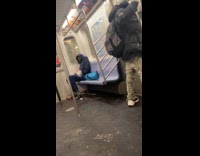 Man dances in front of subway door
