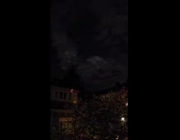 Lights move on gray clouds night sky