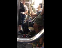 Guy brushes blonde wig with comb on subway train