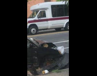 Black car missing tires food container in hood