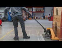 Long pallet trolley pulled inside the warehouse
