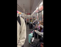 Guy does wavy dances in train 