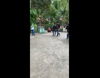 Woman sits on ground holds banana and takes a picture