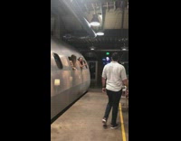 Two girls pose metal submarine restaurant window