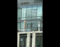 Girl stand pose on ladder building balcony