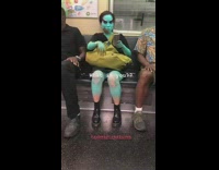 Woman subway blue skin body paint green bag