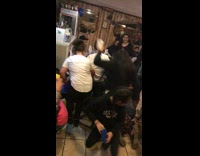 woman in black falls on children trying to catch candy