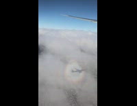 Round rainbow outside the airplane window