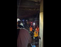 People escorted out by FDNY subway emergency exit