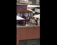 Woman orange bikini violet wall party building