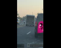 Man sits on back of open moving truck