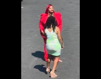 Collab IITW - Woman red outfit poses at parking lot