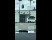 Guy jogs while he juggles two football