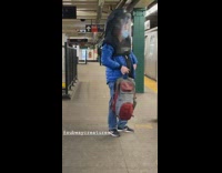 Person wears face mask under black hood 