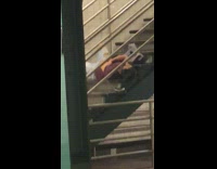 Man asleep middle of stairs into subway