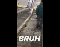 Rat runs down escalator stairs with guy green jacket on right side